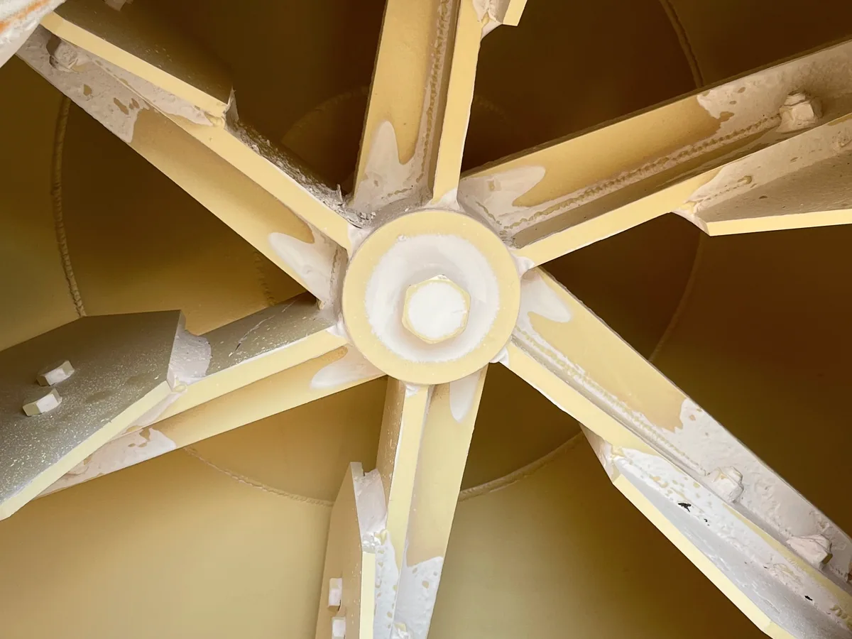 Inside a classifier housing, looking down the spider arms onto the secondary air distribution cone