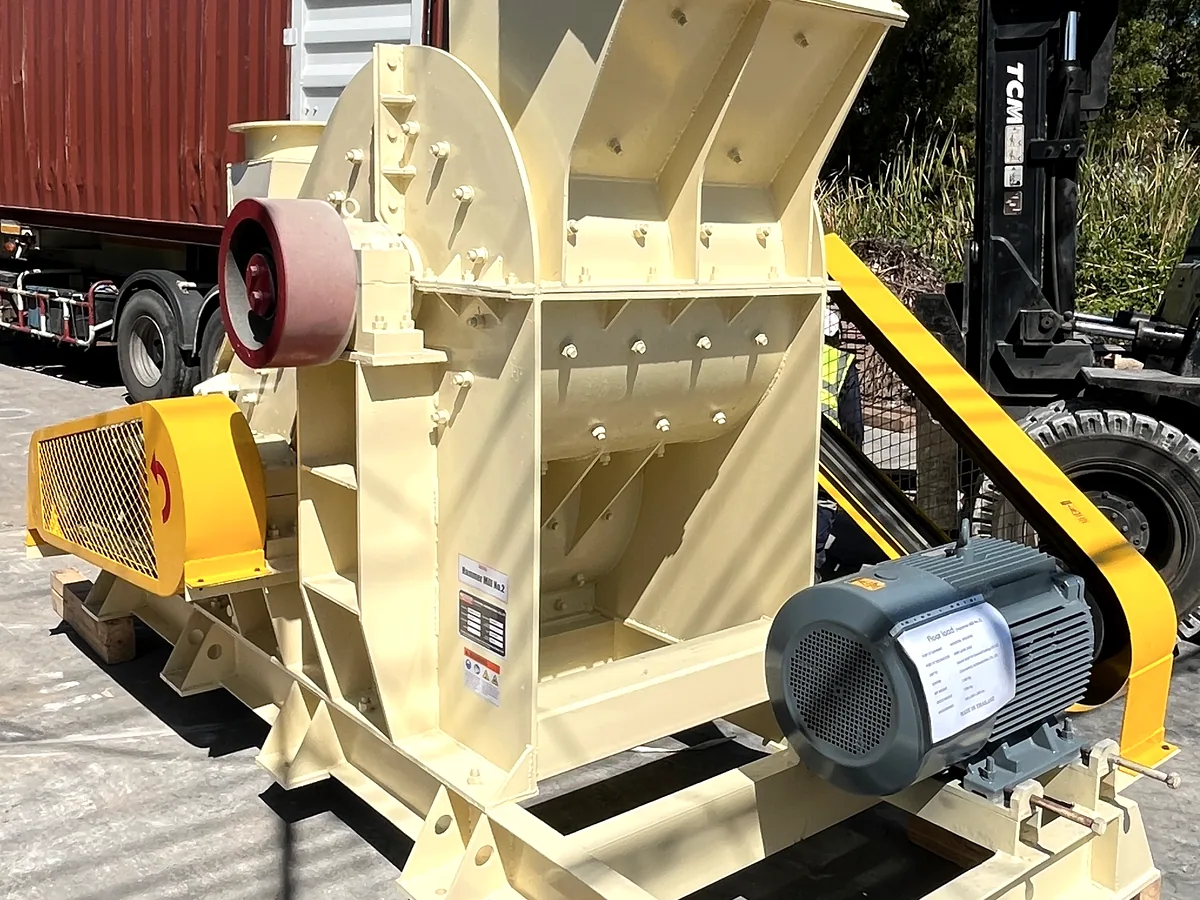 THOR hammer mill on its fabricated skid base, feed hopper and belt-driven rotor housing with motor