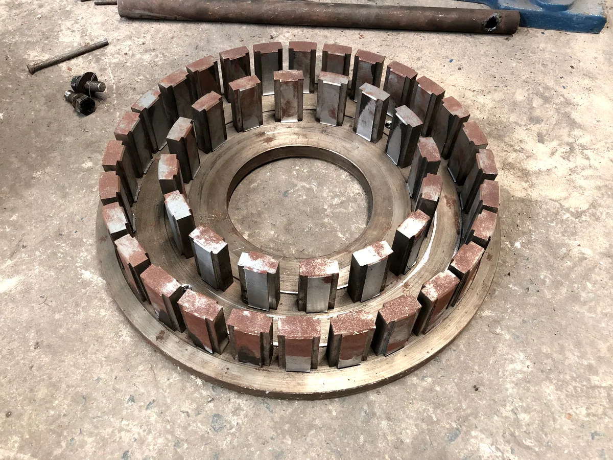Stator pin ring lifted out of a pin mill, showing the hardened pins and their wear pattern